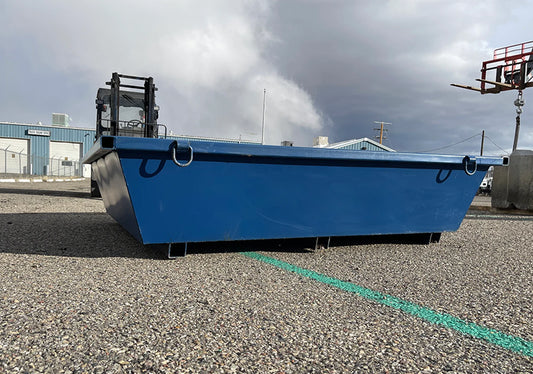 Blue metal dumpster on a concrete surface with a cloudy sky in the background