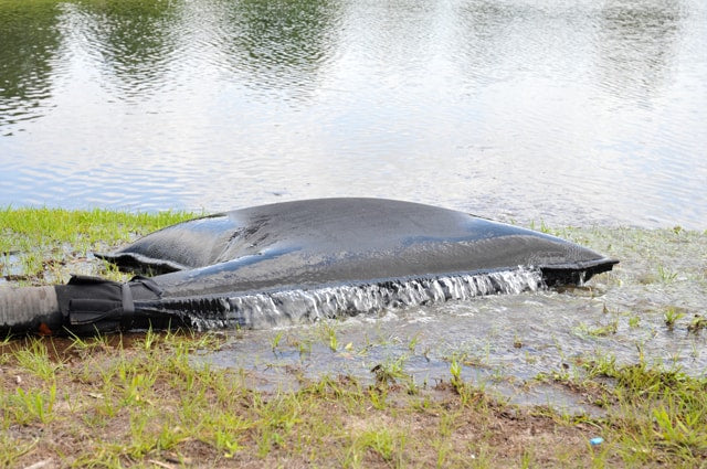 Flooded area with a large black object partially submerged in water